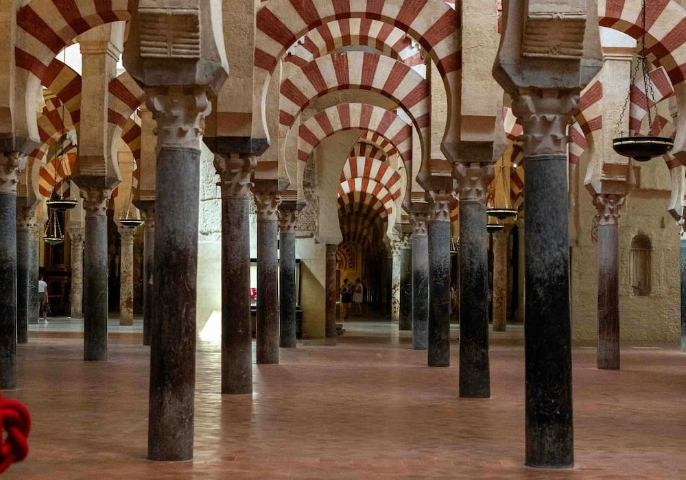 Interior of the Mezquita-Cathedral of Córdoba with its iconic red and white arches