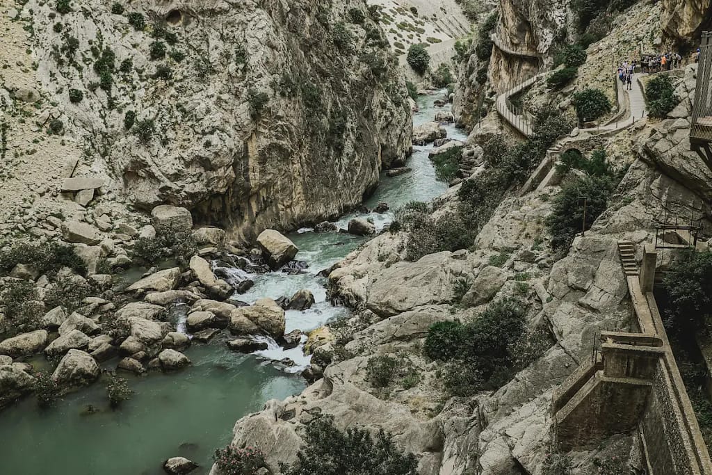 Caminito del Rey gorge with river flowing between steep limestone cliffs in El Chorro