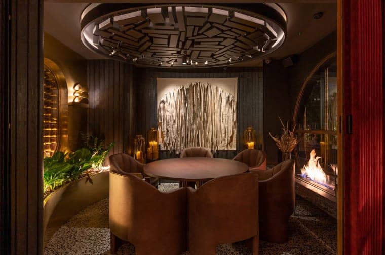 Interior of Leña Marbella restaurant, warm glowing steakhouse seating area